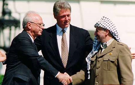 As Bill Clinton beams, Yitzhak Rabin and Yasser Arafat shake hands at the 1993 Oslo Accords ceremony in Washington, D.C. 
