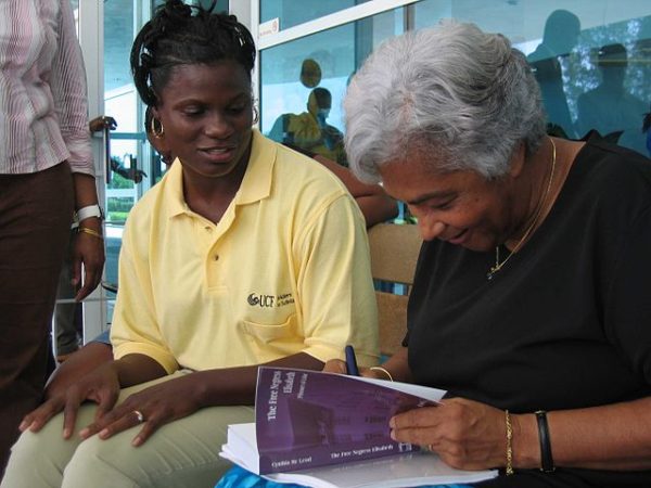 Cynthia McLeod, right, autographs a book