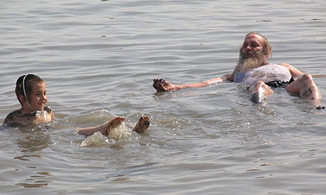 Assi Dayan, right, and Ilan Griff float in the Dead Sea