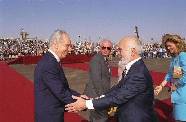 Shimon Peres greets King Hussein of Jordan in 1994. Israeli Prime Minister Yitzhak Rabin is in the background