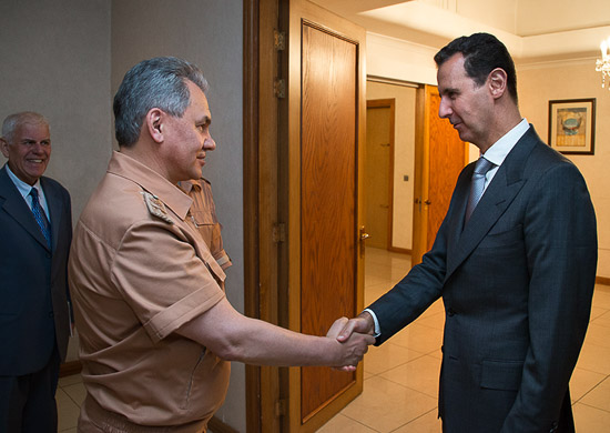 Syrian President Bashar al-Assad greets Russian Defence Minister Sergei Shoigu in Moscow